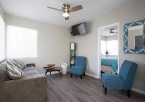 a living room with a couch and blue chairs at MB Jamaica FLAT - Steps 2 Mission Beach in San Diego