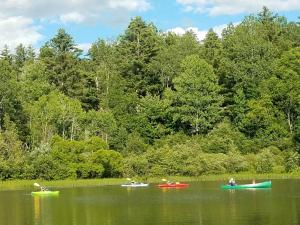a group of people in boats on a lake at Commodores Inn in Stowe