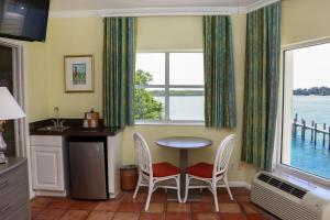 a kitchen with a table and two chairs and a window at Jupiter Waterfront Inn in Jupiter
