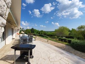 a table and chairs on a patio with a view at La Marquière - Gite Val de Loire in Onzain