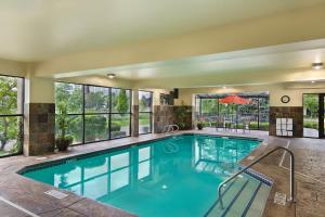 a swimming pool in a hotel with a large window at Oxford Suites Spokane Downtown in Spokane