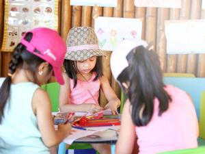 a group of young girls sitting at a table at Novotel Lombok Resort & Villas in Kuta Lombok