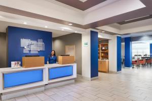 a woman standing in the lobby of a hospital at Holiday Inn Express Palatka Northwest, an IHG Hotel in Palatka