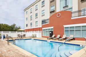 a swimming pool in front of a building at Holiday Inn Express Palatka Northwest, an IHG Hotel in Palatka