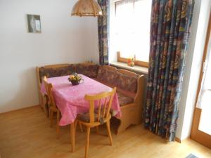 a dining room with a table and a couch at Haus An der Abens in Bad Gögging