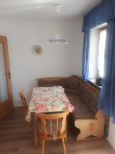 a table and a couch in a room with a table and chairs at Haus An der Abens in Bad Gögging