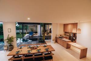 an open kitchen and living room with a table and chairs at LeBAOH VILLA - Lembongan island in Nusa Lembongan