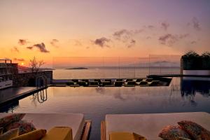a swimming pool with a view of the ocean at Myconian Korali Relais & Chateaux in Mýkonos City