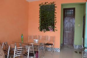 a dining room with a table and chairs and a door at Shah Guest House in Gilgit