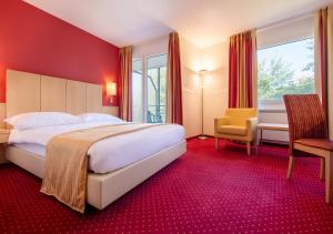 Ein Bett oder Betten in einem Zimmer der Unterkunft Hotel et Centre Thermal d'Yverdon-les-Bains