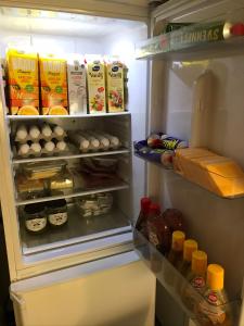 a refrigerator filled with lots of food and drinks at Gävle Bed & Breakfast in Gävle