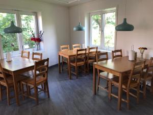 a dining room with wooden tables and chairs at Gävle Bed & Breakfast in Gävle