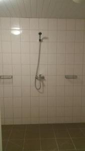 a bathroom with a shower with a shower head at Raasiku Hotell in Raasiku