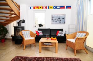 a living room with a couch and chairs and a table at Haus TimpeTe am Breetzer Bodden in Vieregge