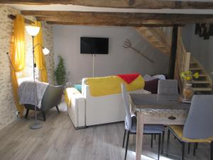 sala de estar con sofá y mesa en La Ferme de la Chapelle-Saint-Jean, en Beynat