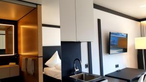 TV a/nebo společenská místnost v ubytování ILL Hotel by WMM Hotels