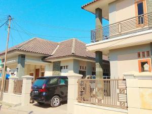 a car parked in front of a house at WISMA ANDALI Syariah near RSUD Cideres in Majalengka