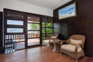 a living room filled with furniture and a tv at Phi Phi Natural Resort-SHA Extra Plus in Phi Phi Islands