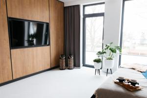 a bedroom with a flat screen tv on a wall at Artisan Park in Kostrzyn nad Odrą