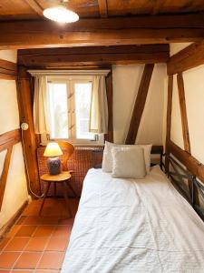 a bedroom with a bed in a room with wooden ceilings at Dom Tkacza in Pieszyce