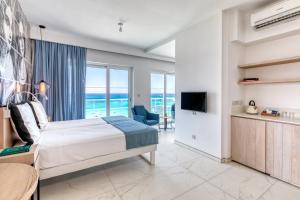 a bedroom with a bed and a view of the ocean at King Jason Protaras - Designed for Adults in Protaras