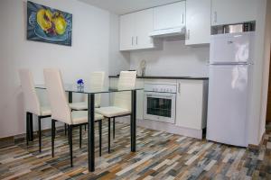 a kitchen with a table and chairs and a refrigerator at Casa Rural la Llar in Vilafamés
