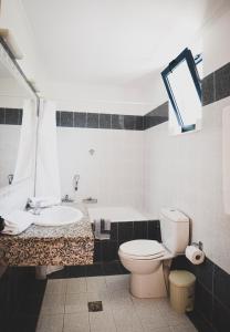 a bathroom with a toilet and a sink at Stegna Star Apartments in Archangelos