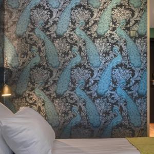 a mural of mermaids on a wall in a bedroom at Thon Hotel Oslo Airport in Gardermoen