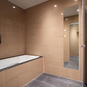 a bathroom with a walk in shower with a tub at Thon Hotel Oslo Airport in Gardermoen