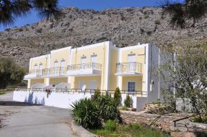 a building in front of a mountain at Marianthi Studios & Apartments in Pefki Rhodes