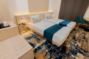 Letto o letti in una camera di Cordia Hotel Yogyakarta - Hotel Dalam Bandara