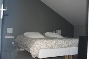 a bedroom with a bed with two pillows at Quai St Paul in Ancenis