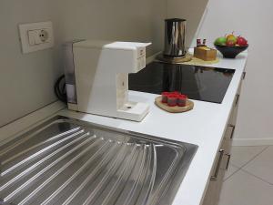 a kitchen with a coffee maker on a counter at Palazzo Talenti 1907 in Trieste