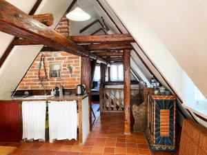 an attic kitchen with a sink and a brick wall at Dom Tkacza in Pieszyce