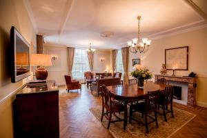 a dining room and living room with a table and chairs at Kasteel de Wittenburg in Wassenaar