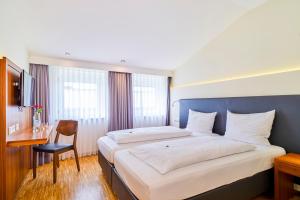 Postel nebo postele na pokoji v ubytování Hotel Apfelbaum