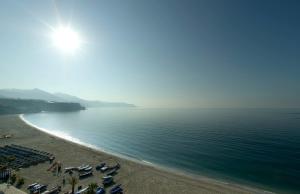 
a beach with a large body of water at Parador de Nerja in Nerja
