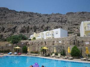a large swimming pool in front of a building at Marianthi Studios & Apartments in Pefki Rhodes