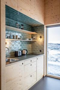 a kitchen with a sink and a window at Aska, Modern Cabin in Myvatn
