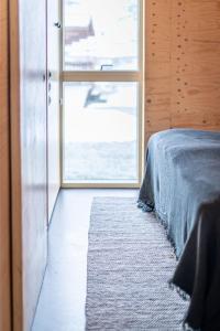 a bedroom with a bed and a large window at Aska, Modern Cabin in Myvatn