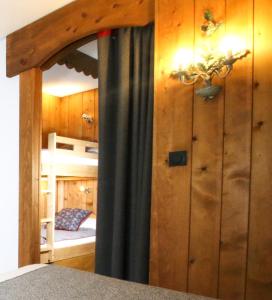 a bedroom with a bunk bed and a mirror at Residence Hôtelière La Renardiere in Samoëns