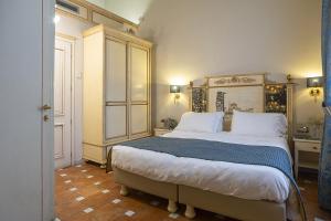 a bedroom with a large bed with a wooden headboard at Hotel Donatello in Florence