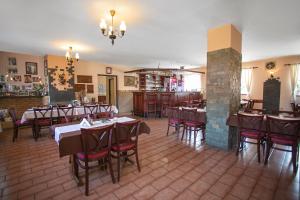 a restaurant with tables and chairs in a room at Penzion Vion in Plzeň