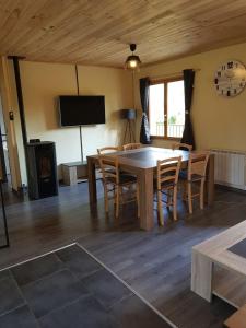 ein Esszimmer mit einem Tisch, Stühlen und einem TV in der Unterkunft maison indépendante in Saint-Amand-en-Puisaye