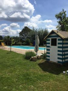 a blue and white shed next to a swimming pool at Chez Raz B&B in Velletri