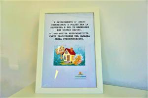 a picture of a frame with a picture of a house at CASA GARDA BLU in Riva del Garda