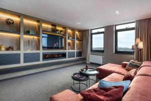 a living room with a couch and a tv at Hotel van der Valk Wolvega-Heerenveen in Wolvega