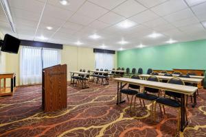 a room with tables and chairs and a green wall at La Quinta by Wyndham Florence in Florence +37 photos