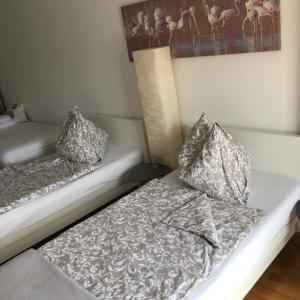 two beds with pillows on them in a room at LG Lovely Apartment in Stockerau