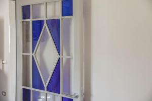 a door with a window with blue glass at Villa Bonelli in Siena